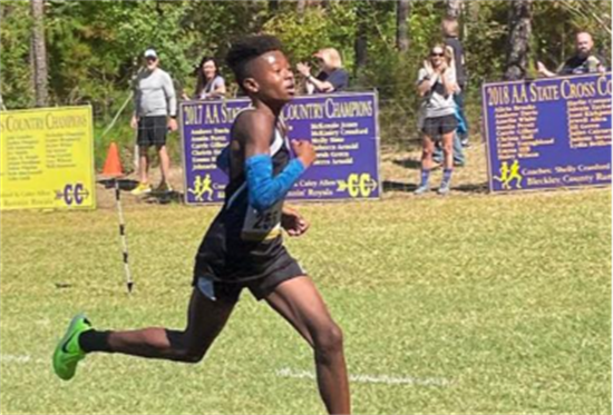 Demetrius Clavino, a Calhoun Middle School eighth grader, powers through his race to the finish line